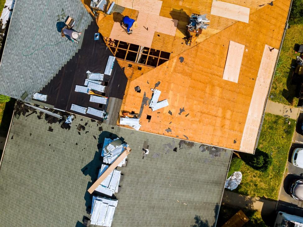 People Restoring A Roof | Featured image for the Roof Restoration Benefits Blog by MHI Roofing